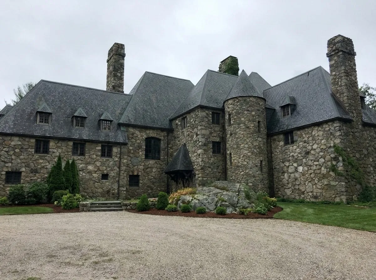 Hilltop Castle, front facade — stone construction with turrets, dormers, and slate roof