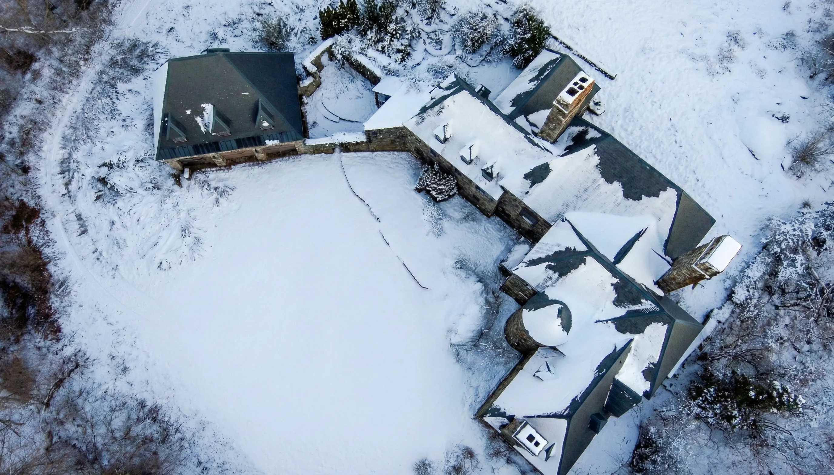 Aerial view — castle and garage in snow, showing the full footprint and courtyard
